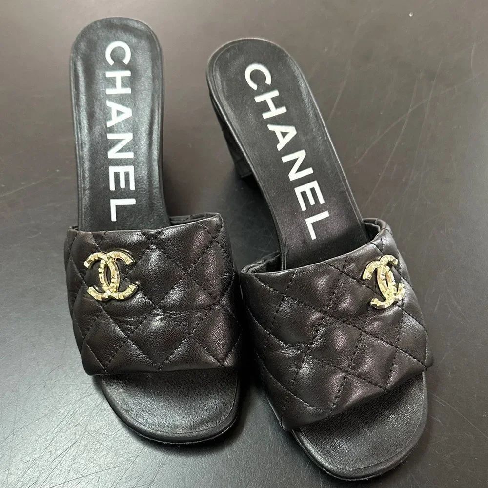 CHANEL Black Quilted Mules with Gold Emblem